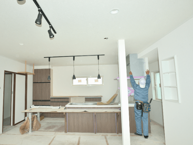 現場でシステムキッチン工事の検査を行う担当者の様子